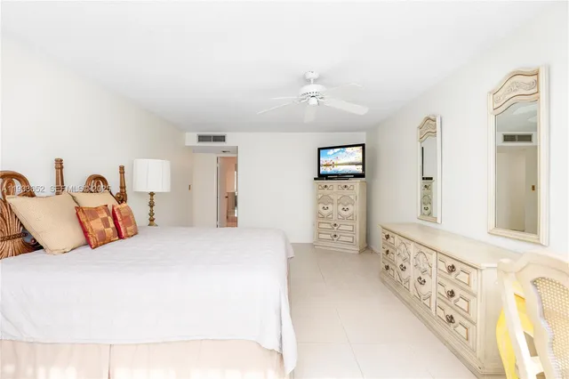 a large white bathroom with a tub and shower