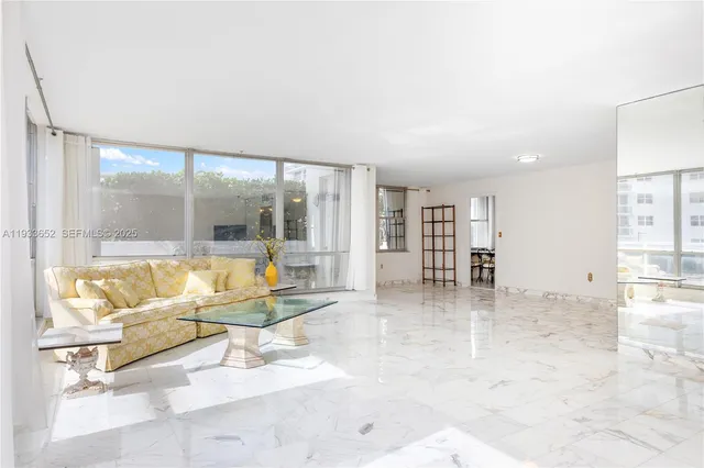 a living room with furniture and floor to ceiling window
