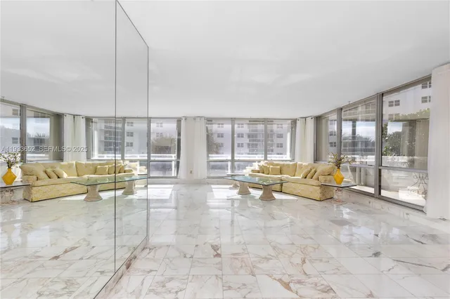 a living room with furniture and a floor to ceiling window