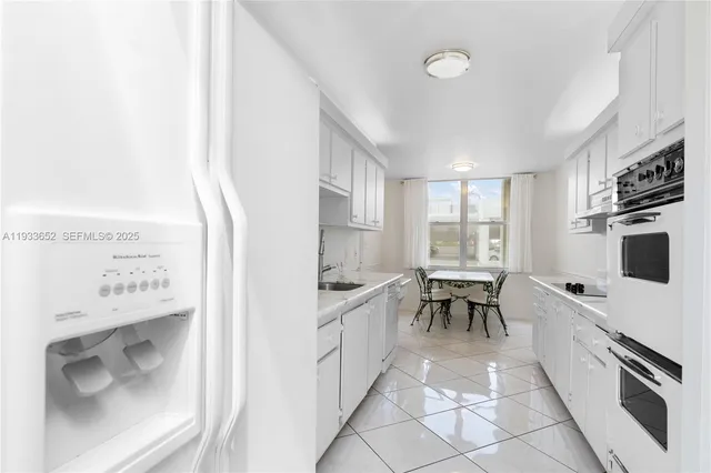 a kitchen with a sink cabinets and window