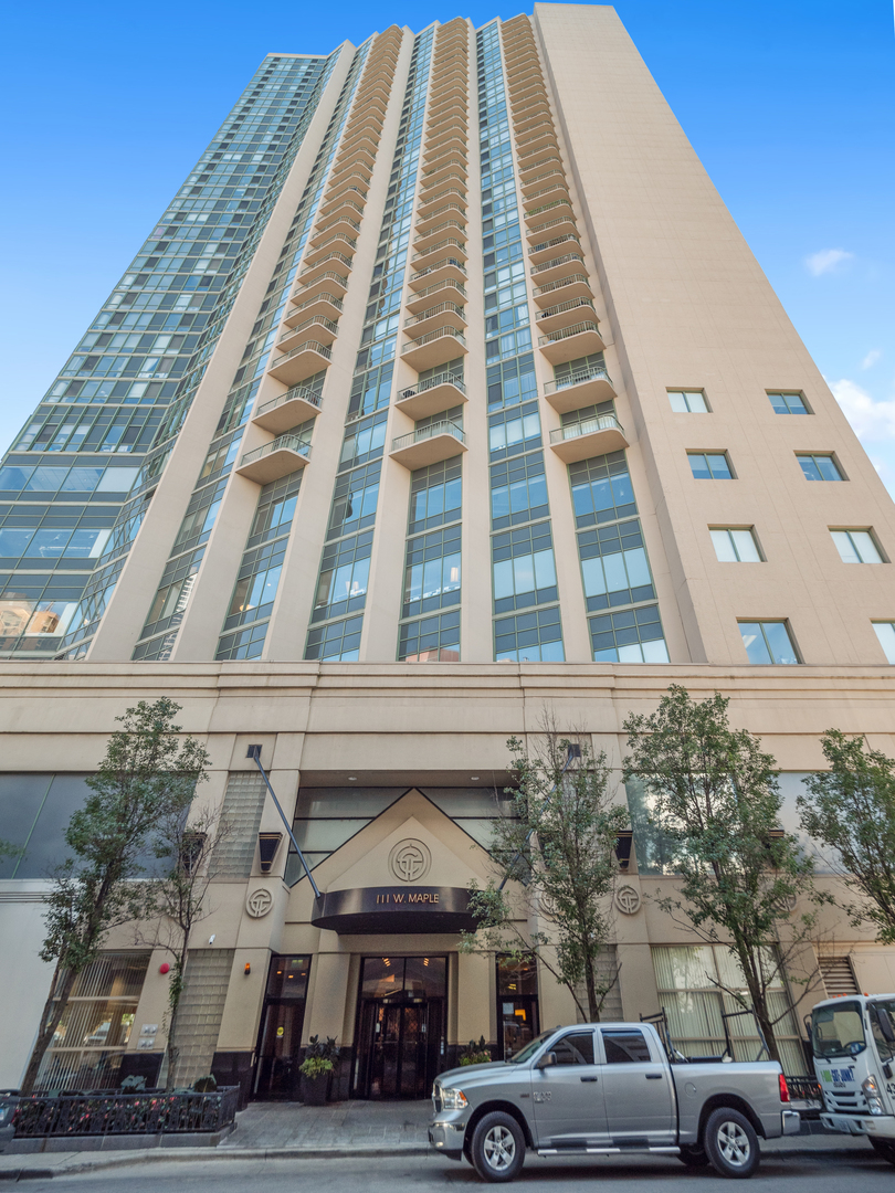 111 West Maple Street, Unit 2010 Chicago, IL 60610 - Photo 2 of 20 a view of a building and car parked