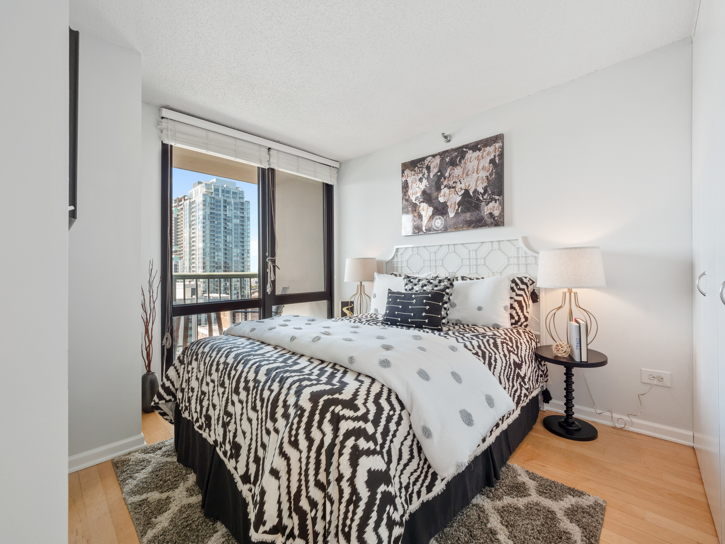 111 West Maple Street, Unit 2010 Chicago, IL 60610 - Photo 14 of 20 a bedroom with a bed and a window