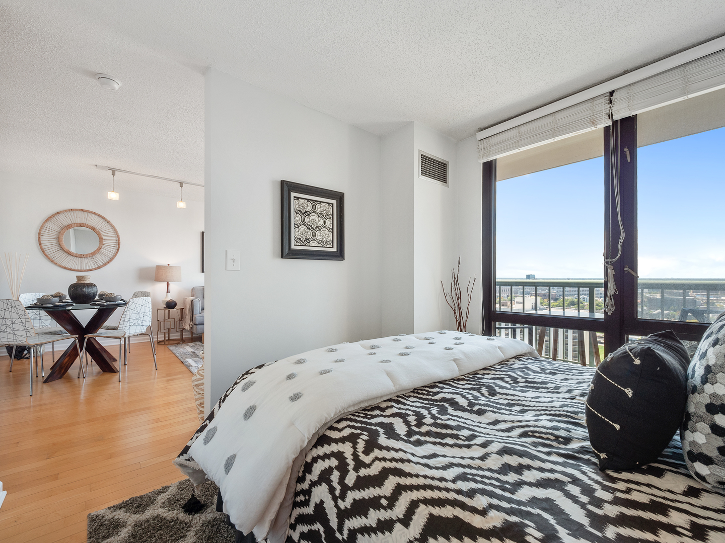 111 West Maple Street, Unit 2010 Chicago, IL 60610 - Photo 15 of 20 a bedroom with a bed a chair and a large window