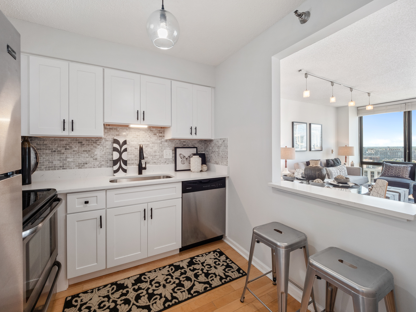 111 West Maple Street, Unit 2010 Chicago, IL 60610 - Photo 9 of 20 a kitchen with granite countertop a sink stove and cabinets