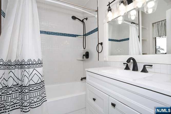 290 Hamilton Place, Unit 4 Hackensack, NJ 07601 - Photo 28 of 50 a bathroom with a sink and a mirror