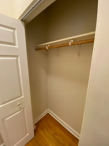a view of a room with wooden floor and a window