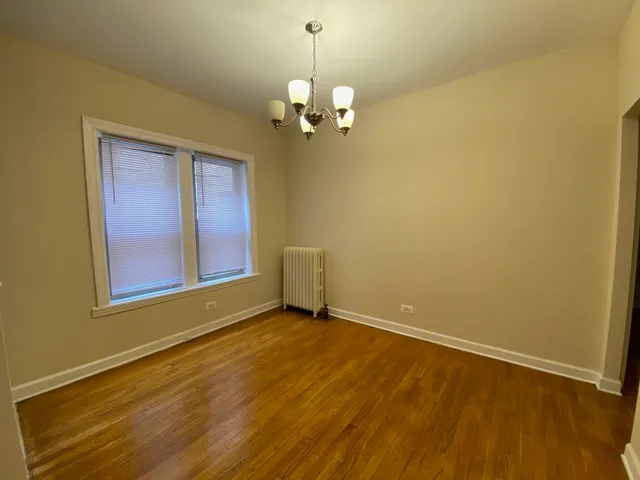 a view of wooden floor and chandelier in a room