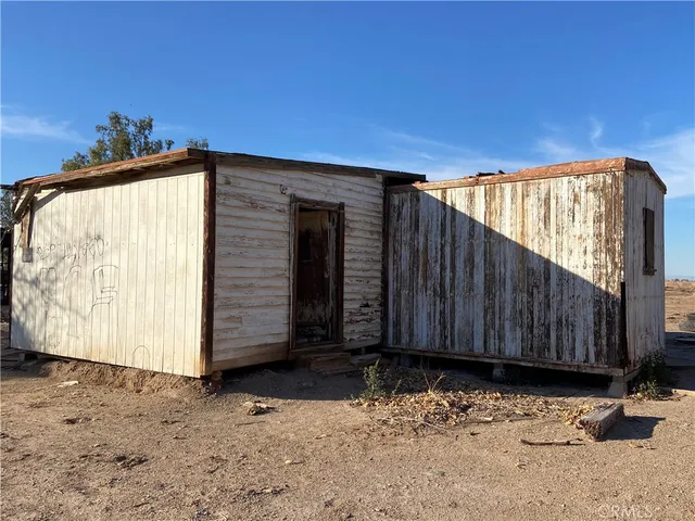 a view of a house with wooden fence
