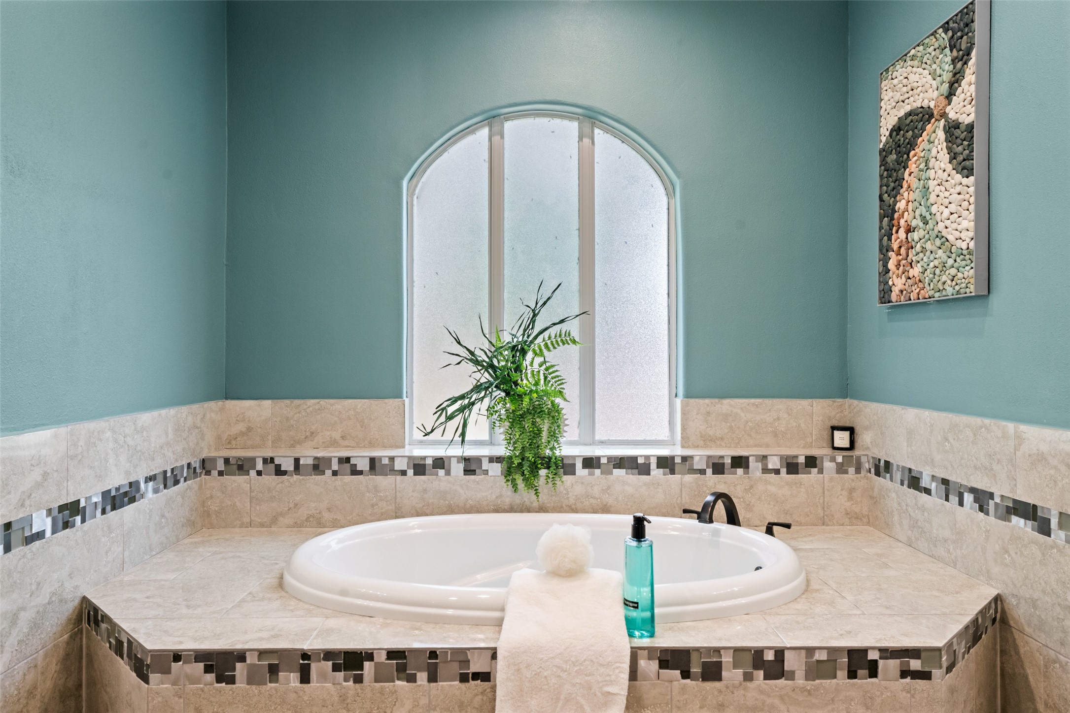 32660 Willow Bend Road Waller, TX 77484 - Photo 45 of 47 Inviting bath featuring a jetted soaking tub, arched window, decorative tile accents, and a relaxing atmosphere.