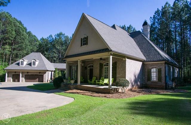 6620 Colaparchee Road Macon, GA 31210 - Photo 2 of 45 a view of a white house with a big yard and potted plants and large trees