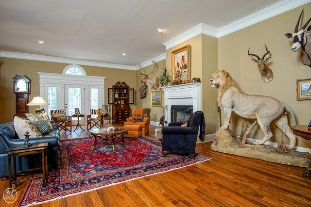6620 Colaparchee Road Macon, GA 31210 - Photo 11 of 45 a living room with furniture a rug and a fireplace