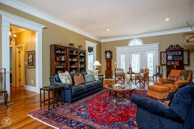6620 Colaparchee Road Macon, GA 31210 - Photo 12 of 45 a living room with furniture a rug and a bookshelf