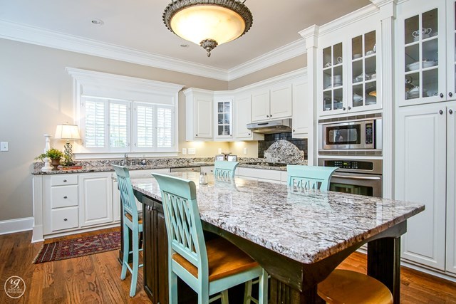 6620 Colaparchee Road Macon, GA 31210 - Photo 15 of 45 a kitchen with granite countertop a stove a sink dishwasher a dining table and chairs with wooden floor
