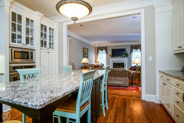 6620 Colaparchee Road Macon, GA 31210 - Photo 19 of 45 a dining hall with couches a flat tv screen and a dining table with wooden floor