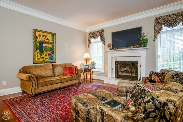 6620 Colaparchee Road Macon, GA 31210 - Photo 21 of 45 a living room with furniture a flat screen tv and a fireplace