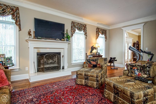 6620 Colaparchee Road Macon, GA 31210 - Photo 22 of 45 a living room with furniture and a fireplace