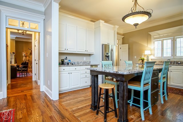 6620 Colaparchee Road Macon, GA 31210 - Photo 23 of 45 a kitchen with granite countertop wooden floor cabinets and dining table