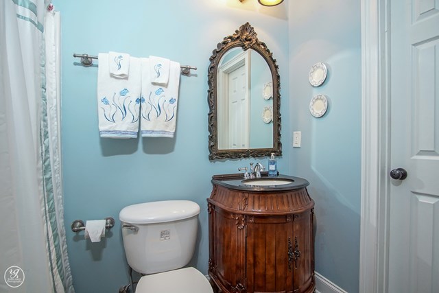 6620 Colaparchee Road Macon, GA 31210 - Photo 25 of 45 a bathroom with a toilet a sink and a mirror