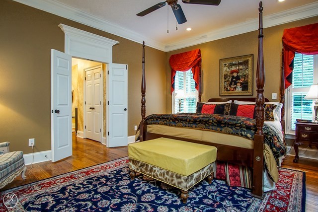 6620 Colaparchee Road Macon, GA 31210 - Photo 37 of 45 a bedroom with a bed and a chandelier