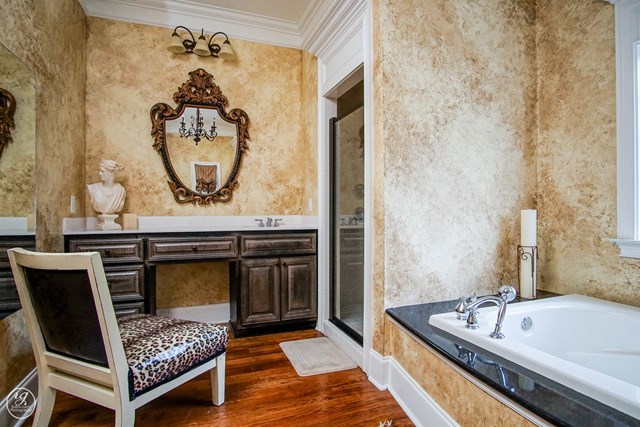 6620 Colaparchee Road Macon, GA 31210 - Photo 39 of 45 a bathroom with a tub a sink and a mirror