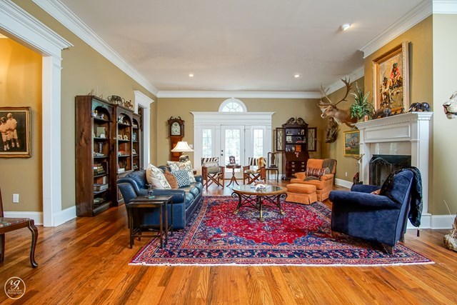 6620 Colaparchee Road Macon, GA 31210 - Photo 10 of 45 a living room with furniture a rug and a fireplace