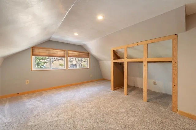 a bed sitting in a room next to a window