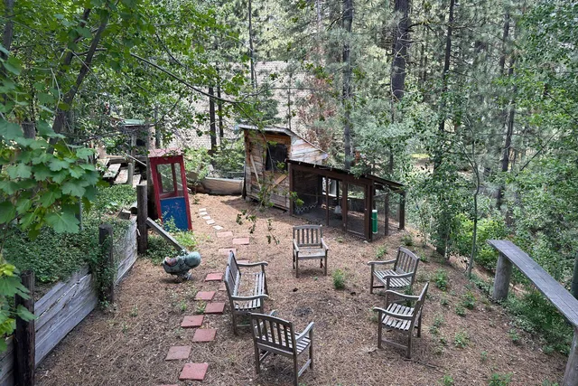 a front view of a house with a yard garage and outdoor seating