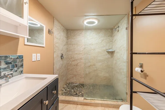 a dining hall with stainless steel appliances granite countertop a stove and a dishwasher next to a window