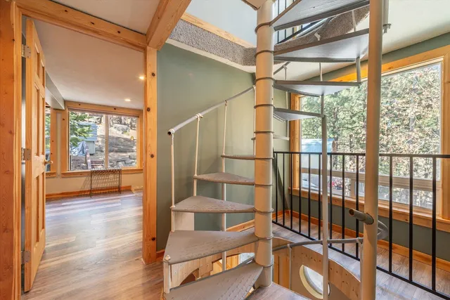 a view of a room with wooden floor and furniture