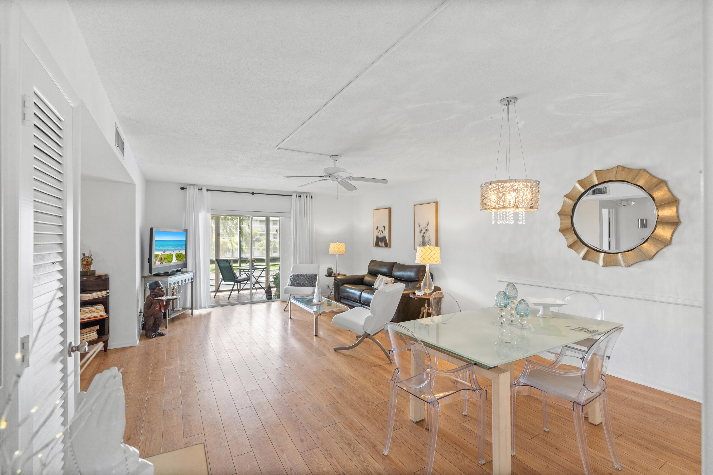 a living room with furniture a fireplace and wooden floor