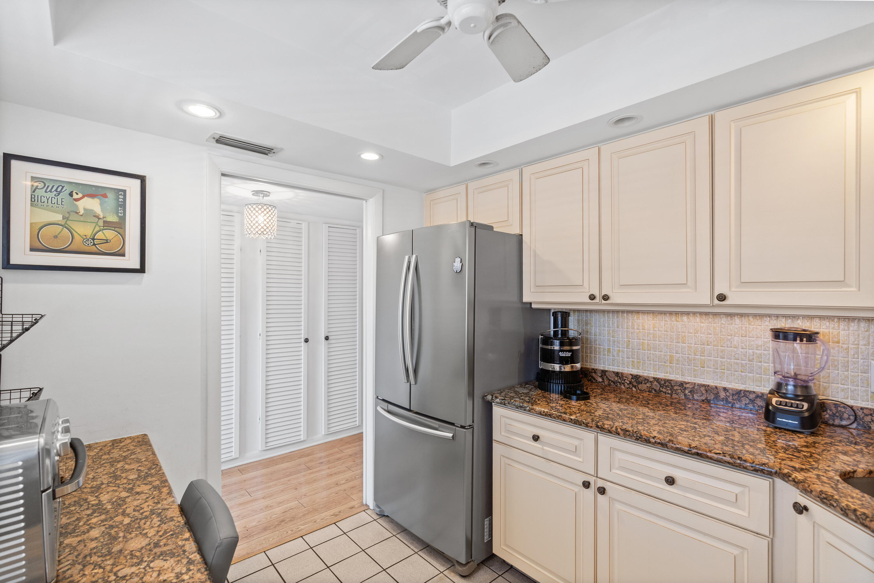 25 Southeast 13th Street, Unit B3 Boca Raton, FL 33432 - Photo 11 of 26 a kitchen with stainless steel appliances granite countertop a refrigerator and a stove top oven