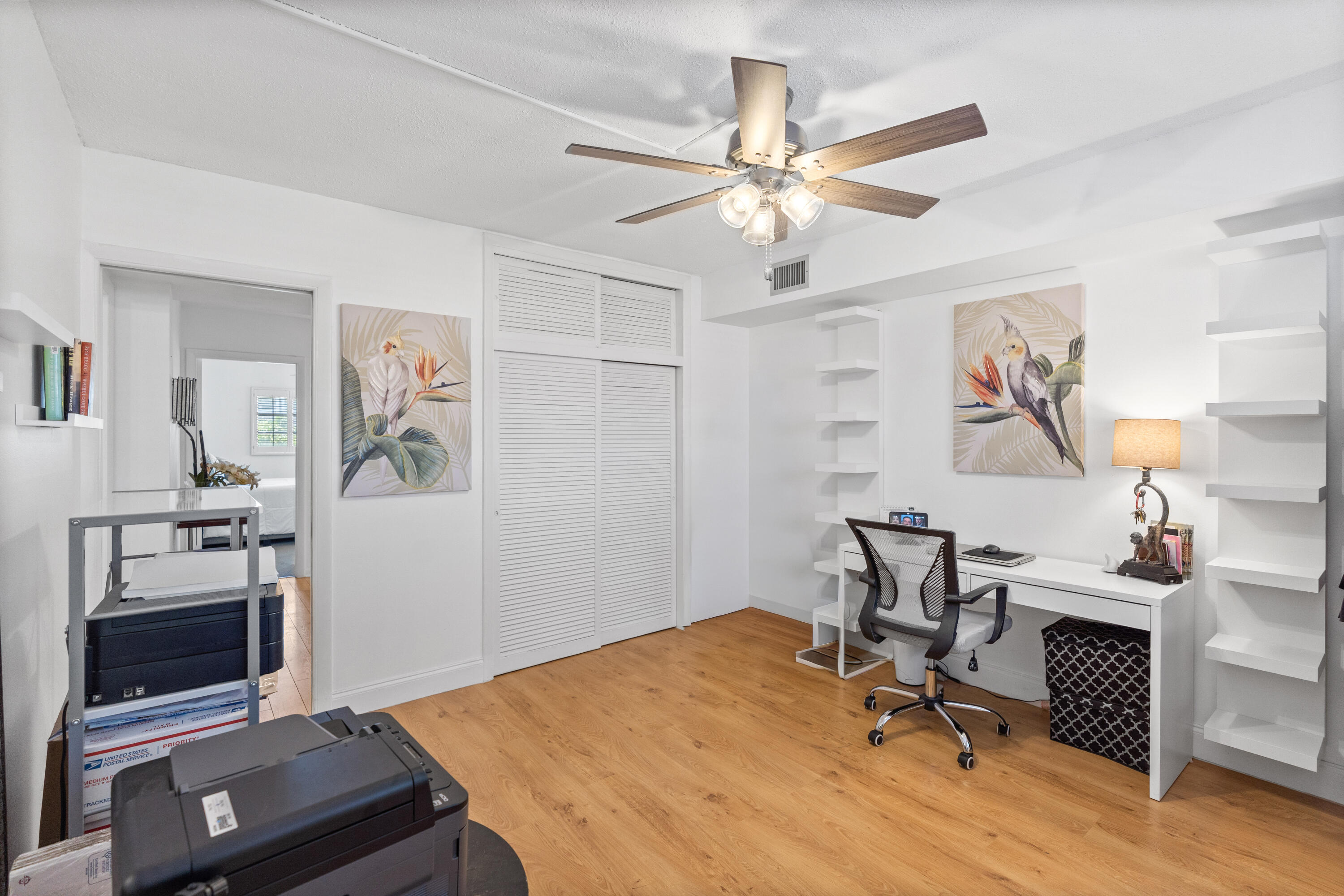 25 Southeast 13th Street, Unit B3 Boca Raton, FL 33432 - Photo 20 of 26 a view of a workspace with furniture and a ceiling fan