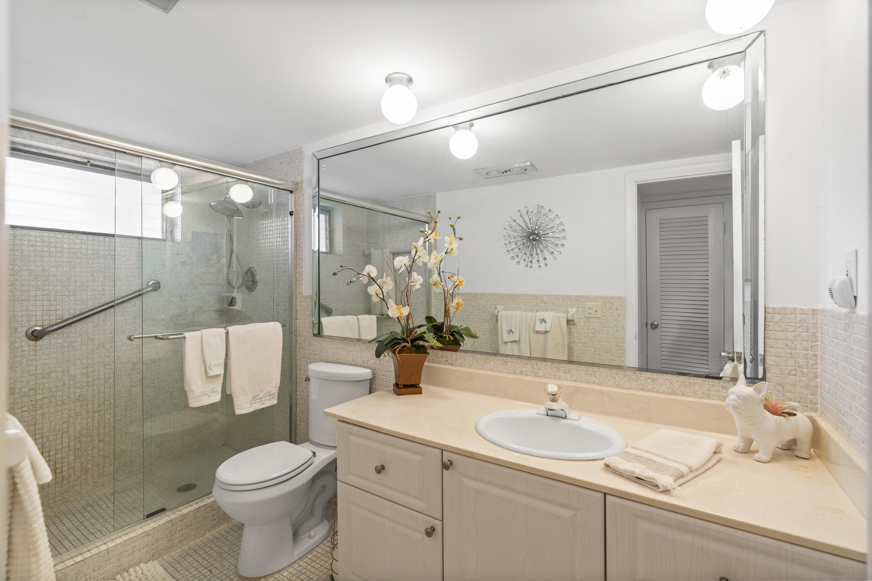 25 Southeast 13th Street, Unit B3 Boca Raton, FL 33432 - Photo 21 of 26 a bathroom with a sink a toilet and shower