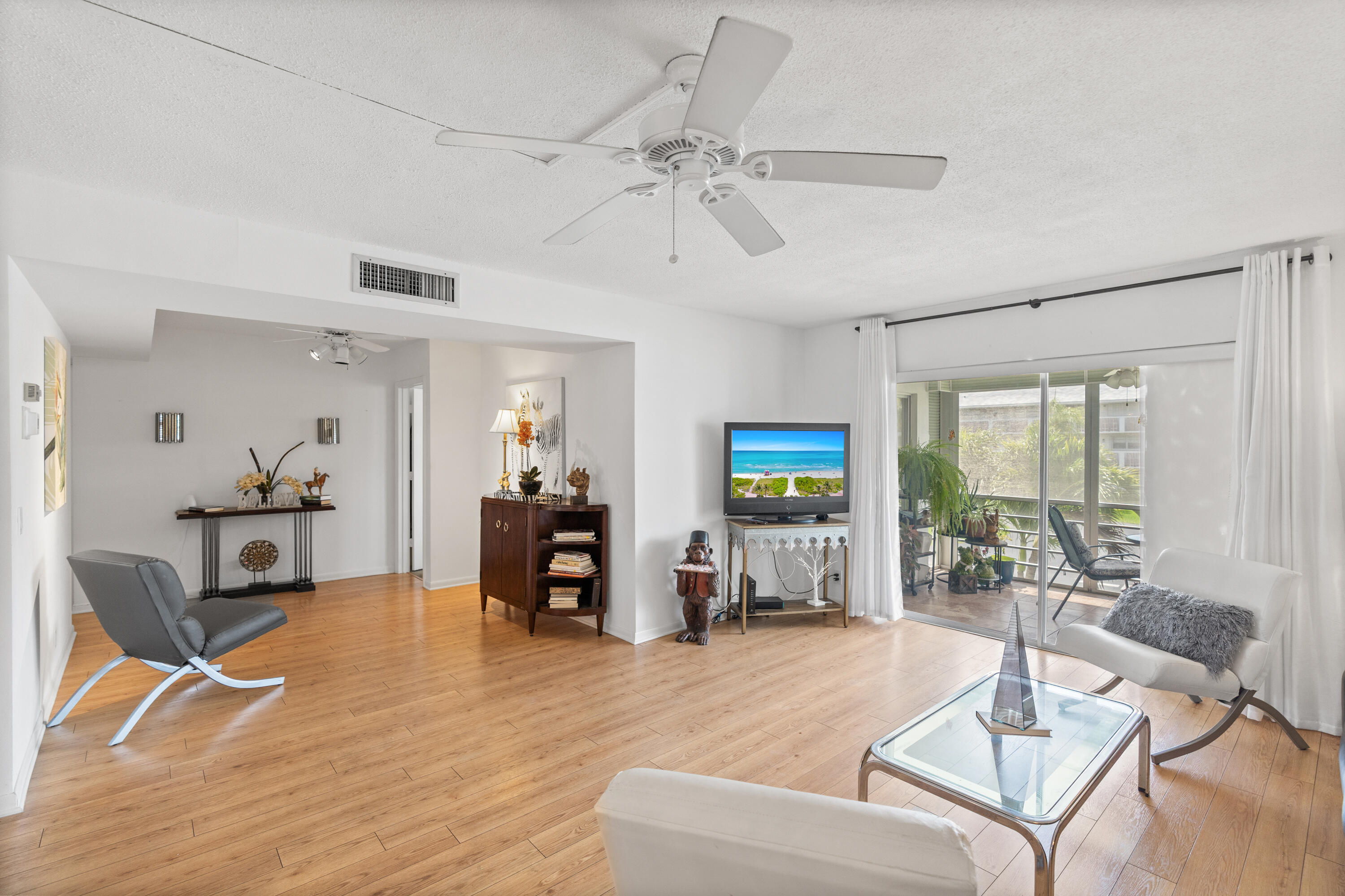25 Southeast 13th Street, Unit B3 Boca Raton, FL 33432 - Photo 3 of 26 a living room with furniture and a table