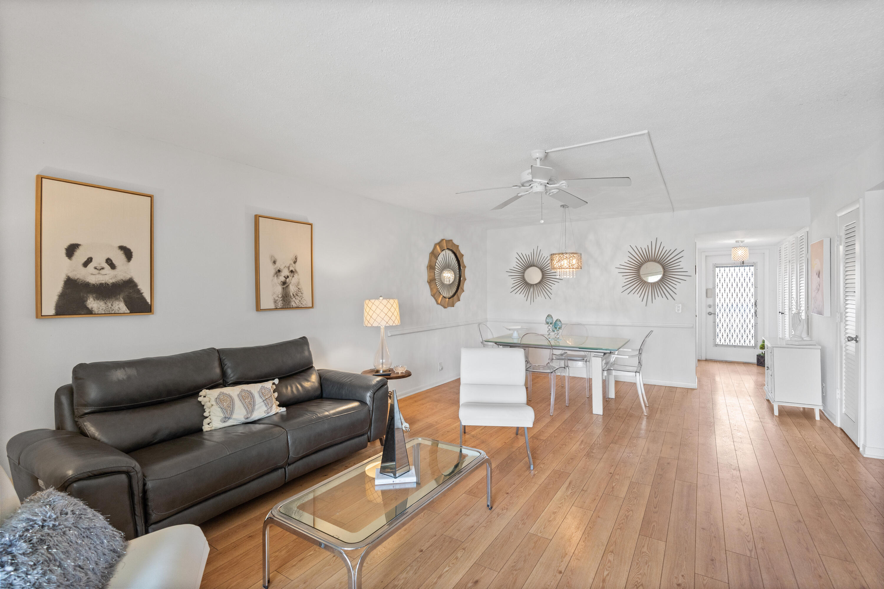 25 Southeast 13th Street, Unit B3 Boca Raton, FL 33432 - Photo 5 of 26 a living room with furniture and a wooden floor