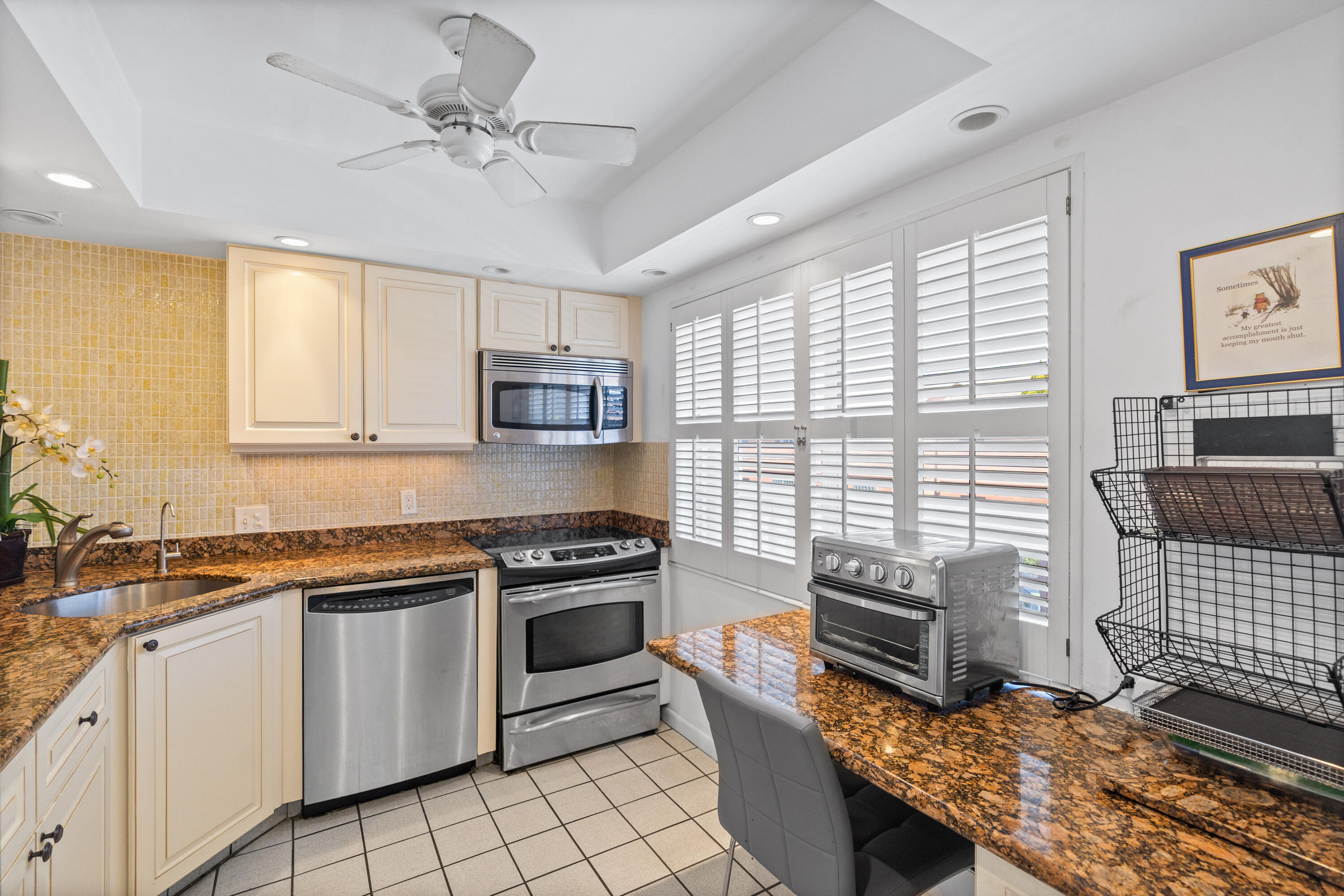 25 Southeast 13th Street, Unit B3 Boca Raton, FL 33432 - Photo 10 of 26 a kitchen with granite countertop a stove sink and microwave