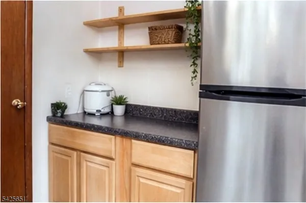 a kitchen with a refrigerator and cabinets