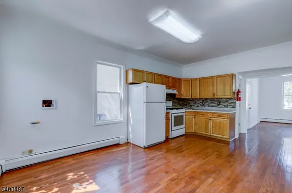 a kitchen with granite countertop white cabinets and white appliances