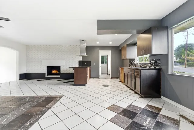 a kitchen with stainless steel appliances kitchen island granite countertop a stove a sink and a granite counter tops