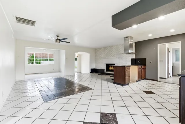 a kitchen with granite countertop a stove a sink and a microwave
