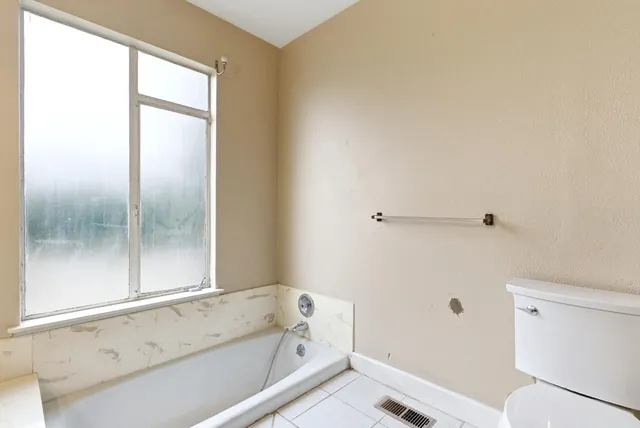 a bathroom with a bathtub and a toilet