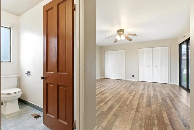 a view of a room with wooden floor and bathroom view