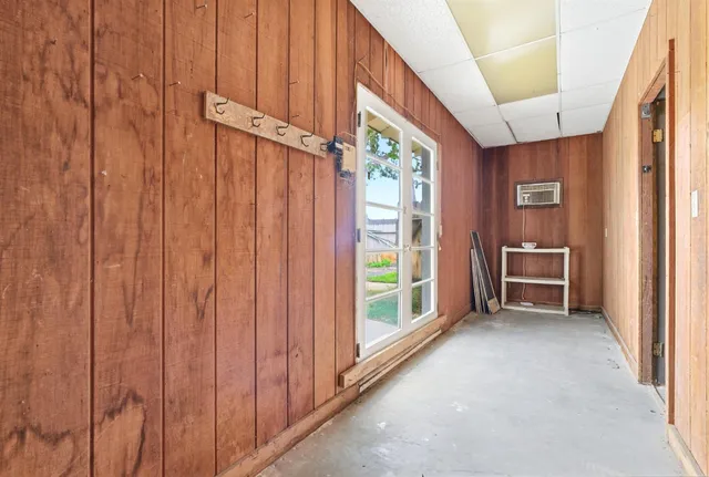 a view of a hallway with entryway wooden floor and front door