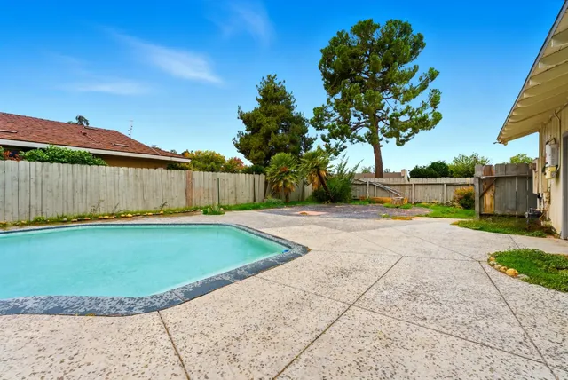 a view of a backyard with swimming pool