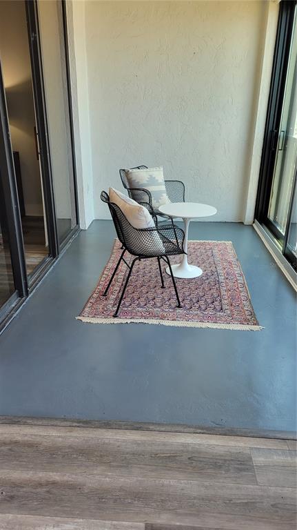 11 Sunset Drive, Unit 704 Sarasota, FL 34236 - Photo 11 of 34 a view of a hallway with wooden floor and chair