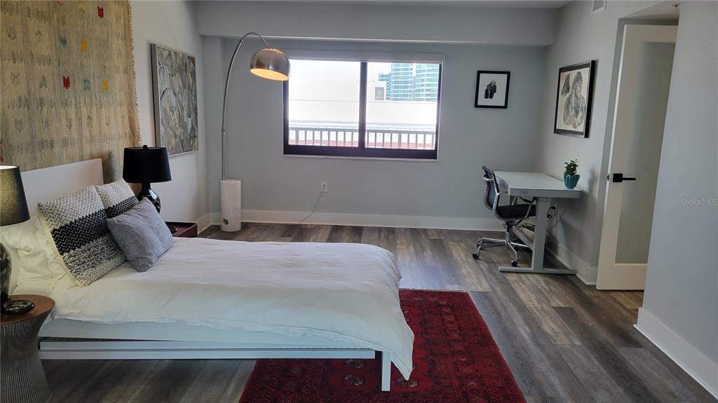 11 Sunset Drive, Unit 704 Sarasota, FL 34236 - Photo 18 of 34 a bedroom with a bed and a window