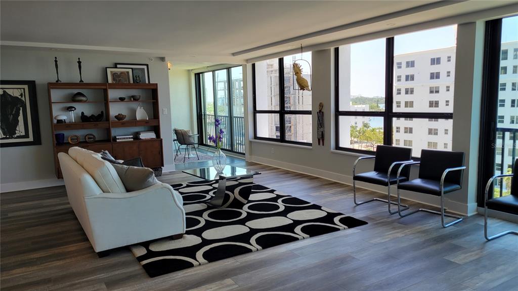 11 Sunset Drive, Unit 704 Sarasota, FL 34236 - Photo 22 of 34 a living room with furniture and a floor to ceiling window