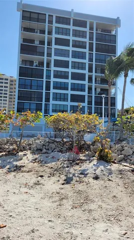 a view of a dry yard with wooden fence