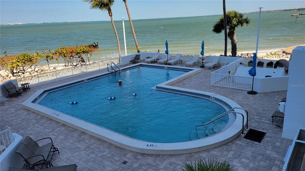 11 Sunset Drive, Unit 704 Sarasota, FL 34236 - Photo 30 of 34 a view of a swimming pool with a lounge chair
