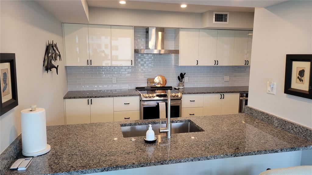 11 Sunset Drive, Unit 704 Sarasota, FL 34236 - Photo 7 of 34 a kitchen with a sink and cabinets
